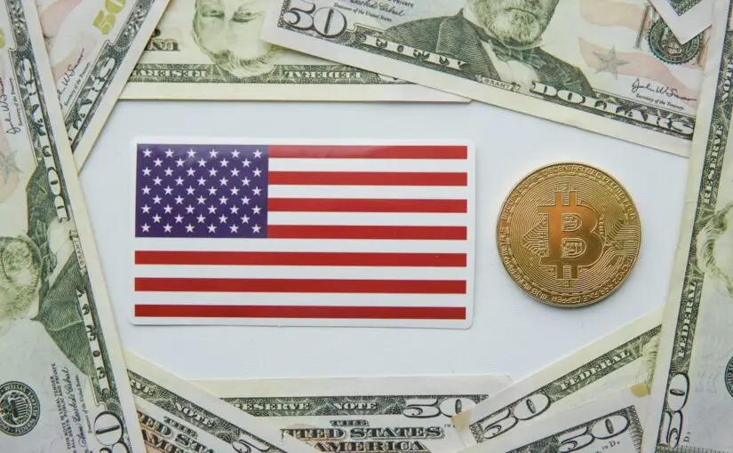 Golden bitcoin BTC and flag of the United States of America USA on the table.